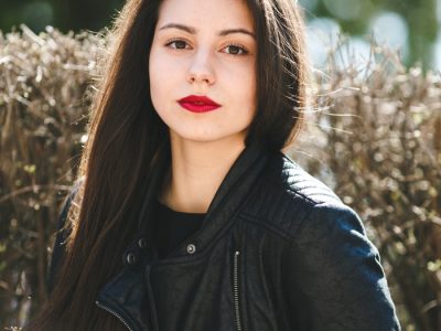 young-beautiful-girl-posing-black-leather-jacket-park